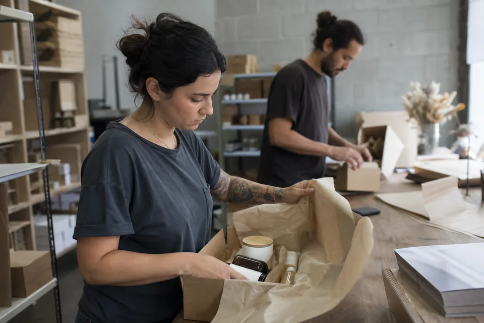 Team packing product gift boxes for creators in a small warehouse